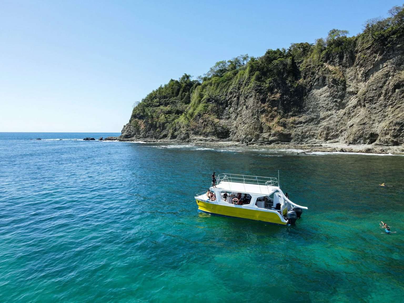 Luxury catamaran sailing along the Costa Rican coast at sunset