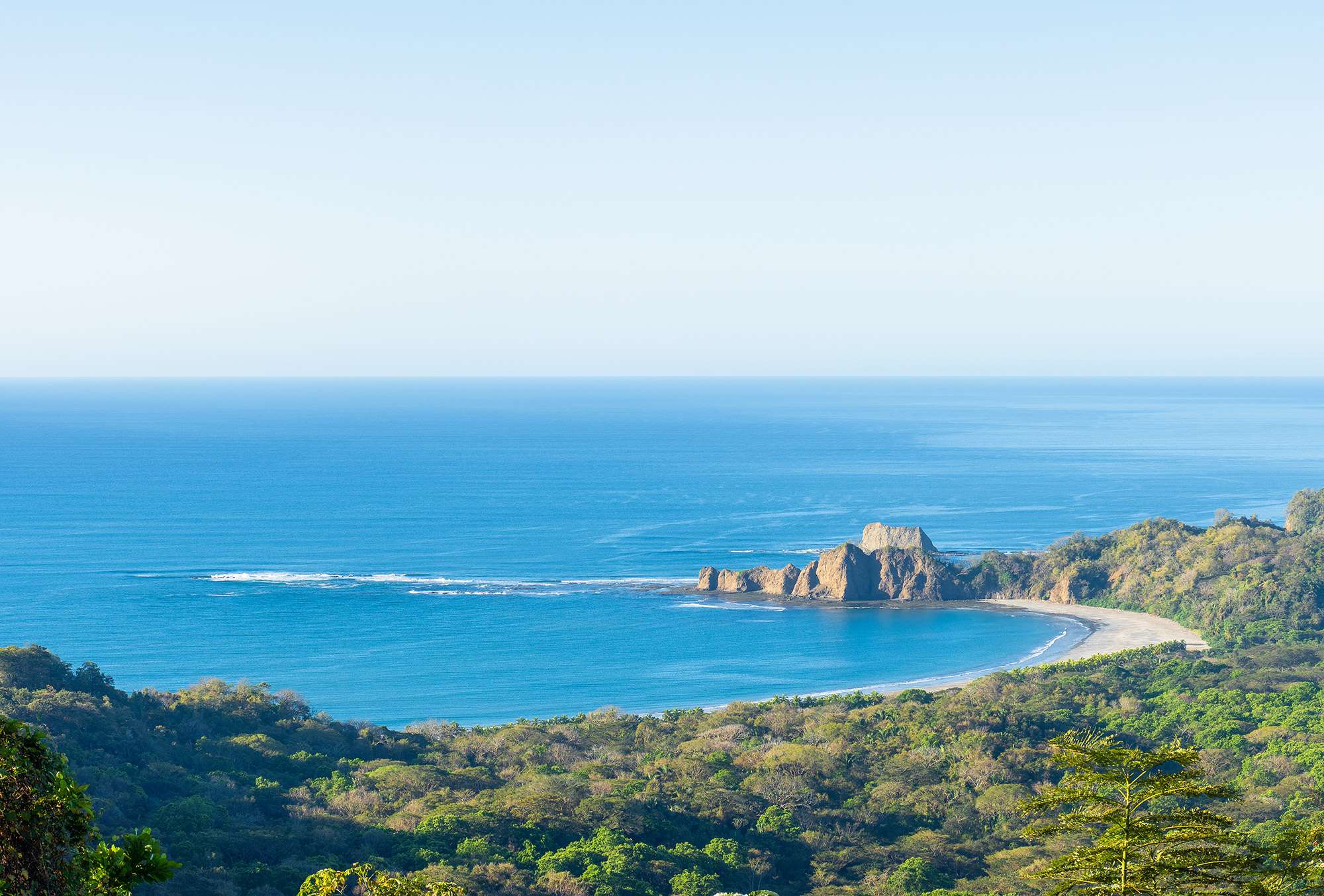 Adventurer exploring a lush Costa Rican jungle during a luxury travel experience.