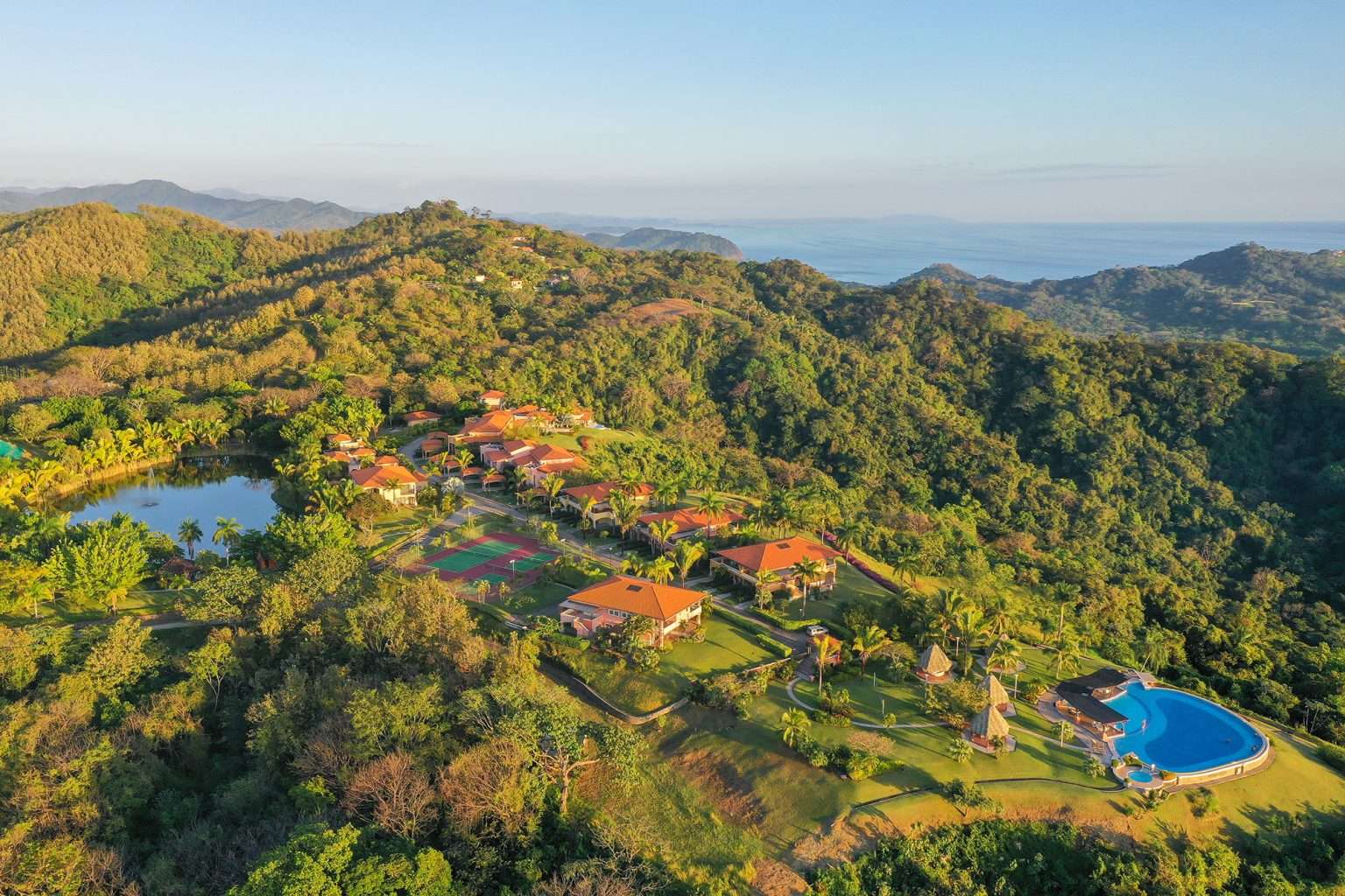 Ventanas del Mar overlooking Playa Carrillo, with luxury homes nestled in lush hills and panoramic ocean views.