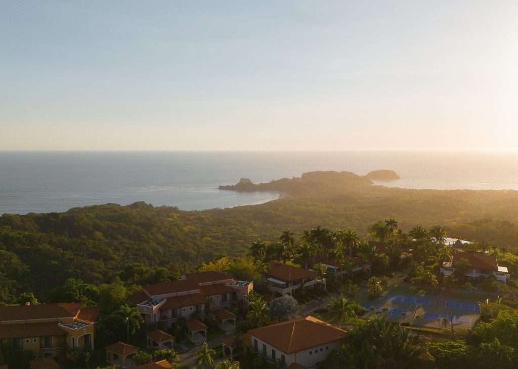Aerial view of low-density beachfront homes surrounded by jungle at Ventanas del Mar Playa Carrillo Costa Rica